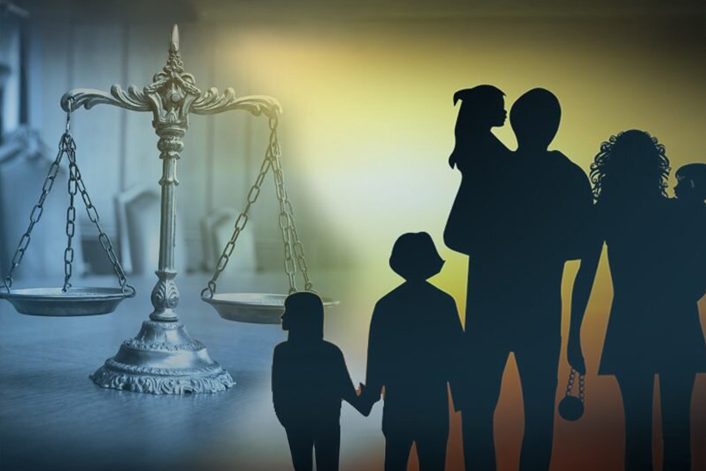 a silhouette of a man holding a child and a scale of justice